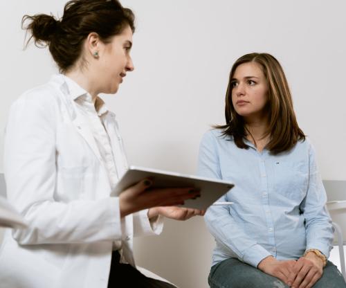 Women discussing the components of a medical surveillance program
