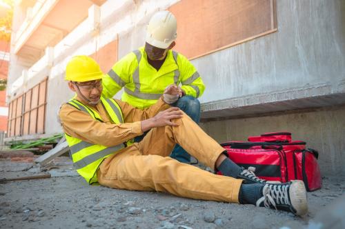 on-site occupational medical clinician assists an injured construction worker mobile medical corporation on-site medical services on-site medical clinic  