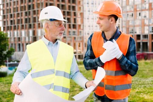 older and younger worker discussing at a construction site generational health gap mobile medical corporation